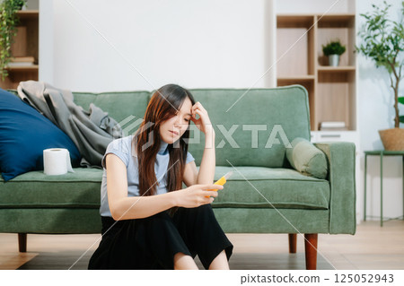 Asian Woman sitting in the sofa with a large number of pills Depressed woman wants to kill herself by drug overdose, depression concept. 125052943
