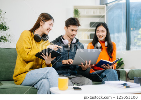 vibrant teamwork, creativity, and learning with young adults using laptops and headphones  in cozy 125053100