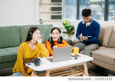 Group of young Asian college students working on his project assignment, using laptop computer 125053131