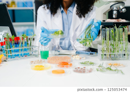Food science as lab scientists test and analyze vegetables for safety and quality using advanced technology Food science as lab scientists test and analyze vegetables for safety and quality using advanced technology 125053474