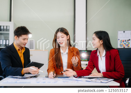 Professional teamwork as business colleagues engage in strategy, planning, and discussion 125053517