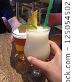 Newlywed couple toasting at dinner in Hawaii 125054502