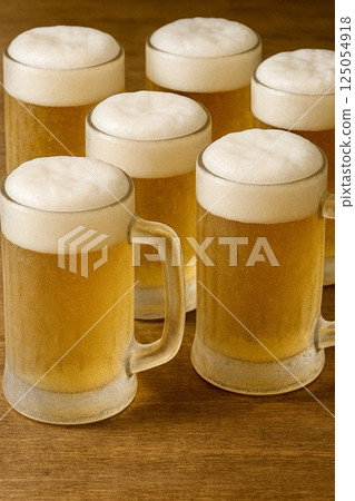 Draft beer poured into a mug Draft beer poured into a mug 125054918