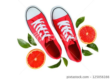Summer shoes, Red sneakers placed among vibrant orange slices and fresh green leaves create a lively composition, isolated on white, PNG Summer shoes, Red sneakers placed among vibrant orange slices and fresh green leaves create a lively composition, isolated on white, PNG 125056166