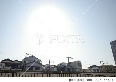 The sun shining down on the city 125056383