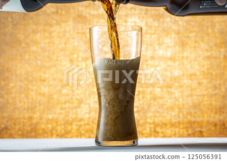 Draft beer being poured into a glass Draft beer being poured into a glass 125056391