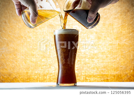 Draft beer being poured into a glass Draft beer being poured into a glass 125056395