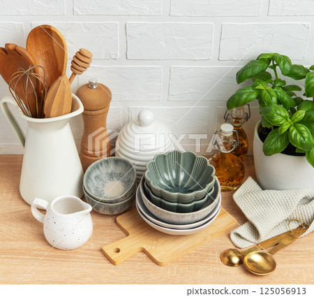 Kitchen utensils, bowls, and spices creating a cozy culinary scene Kitchen utensils, bowls, and spices creating a cozy culinary scene 125056913