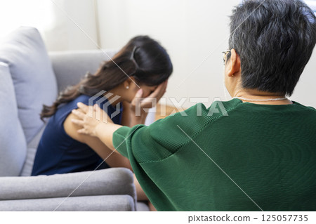 Asian psychologist doctor having session with young depressed woman in clinic. Psychology and mental therapy concept. Asian psychologist doctor having session with young depressed woman in clinic. Psychology and mental therapy concept. 125057735