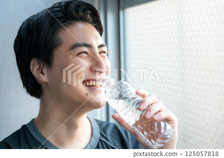 Man drinking water at the gym Man drinking water at the gym 125057818