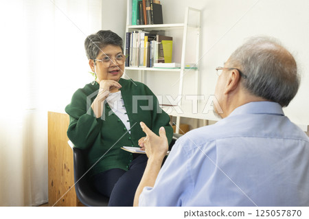 Parents telling the psychologist about family or child problems. Depressed girl and her parent or grandpa having session with psychiatrist in clinic. Parents telling the psychologist about family or child problems. Depressed girl and her parent or grandpa having session with psychiatrist in clinic. 125057870
