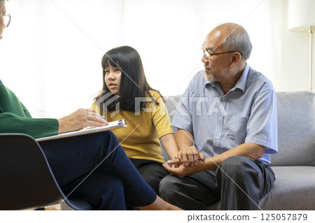 Parents telling the psychologist about family or child problems. Depressed girl and her parent or grandpa having session with psychiatrist in clinic. 125057879