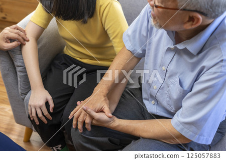 Parents telling the psychologist about family or child problems. Depressed girl and her parent or grandpa having session with psychiatrist in clinic. Parents telling the psychologist about family or child problems. Depressed girl and her parent or grandpa having session with psychiatrist in clinic. 125057883