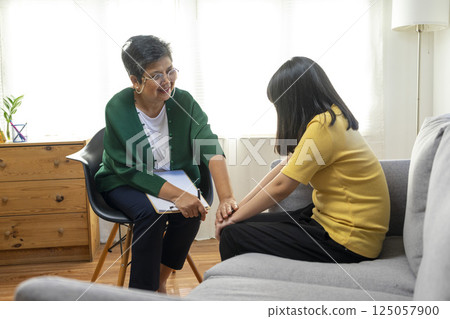 Depressed asian girl having consultation with psychologist at clinic. Depressed asian girl having consultation with psychologist at clinic. 125057900