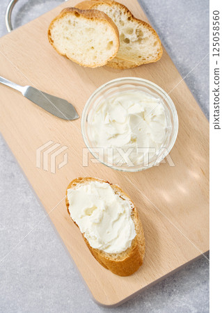 Cream cheese spread on French bread 125058560
