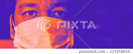 Closeup of man in mask in vivid neon hues 125058654
