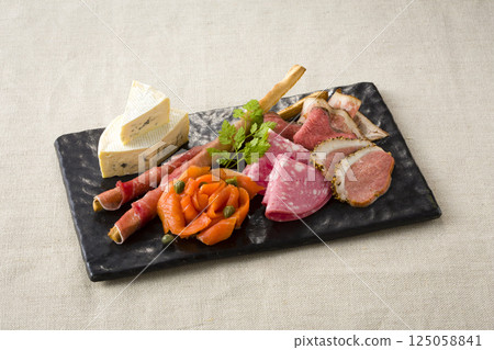Assorted snacks including cheese and prosciutto 125058841