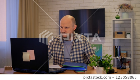 Man refines syntax through remote programming environment, where programming fosters flexible hours, letting programming open global opportunities in dynamic tech sphere Remote work of man at computer Man refines syntax through remote programming environment, where programming fosters flexible hours, letting programming open global opportunities in dynamic tech sphere Remote work of man at computer 125058863
