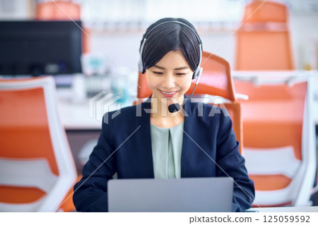 Operator woman wearing a suit working in the office 125059592