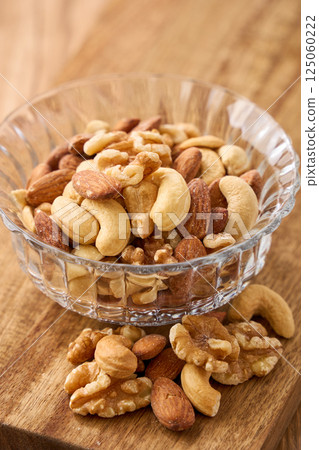 Mixed nuts in a glass bowl Mixed nuts in a glass bowl 125060222