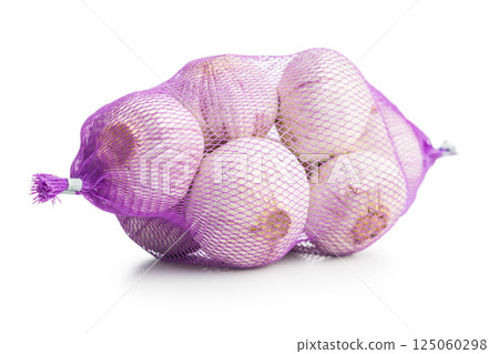 Single clove garlic wrapped in a net bag isolated on white background. 125060298