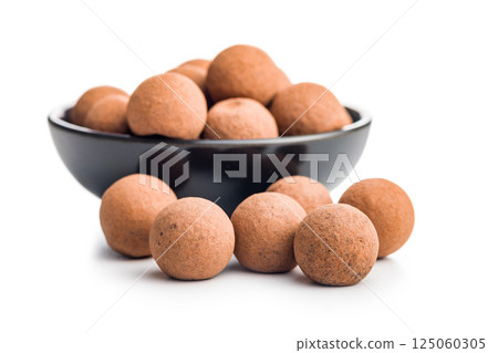 Chocolate truffles with cocoa powder and caramel filling  isolated on white background. 125060305