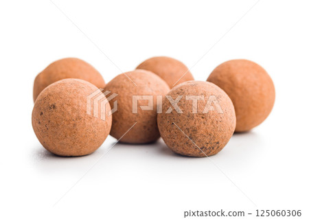 Chocolate truffles with cocoa powder and caramel filling  isolated on white background. 125060306