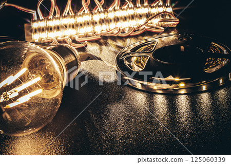 Electric LED components with a filament bulb on a dark background Electric LED components with a filament bulb on a dark background 125060339