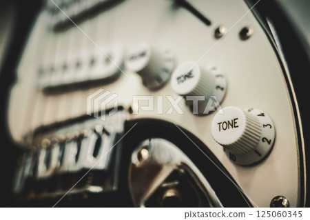 Close-up of electric guitar tone knobs with shallow depth of field 125060345