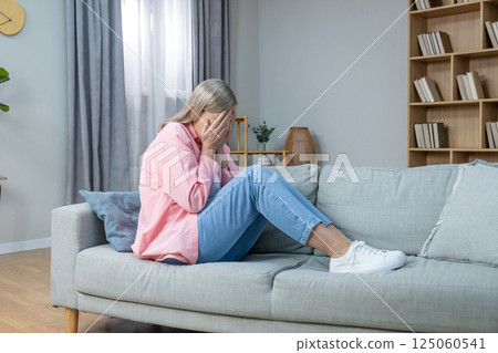 Aging woman in pink shirt feeling emotionally stressed and frustrated 125060541