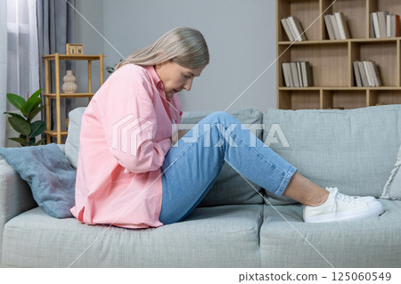 Aging woman in pink shirt feeling emotionally stressed and frustrated Aging woman in pink shirt feeling emotionally stressed and frustrated 125060549