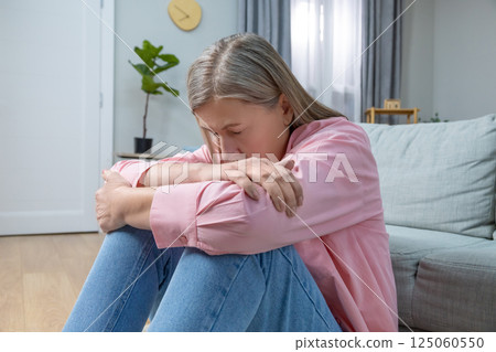 Aging woman in pink shirt feeling emotionally stressed and frustrated 125060550