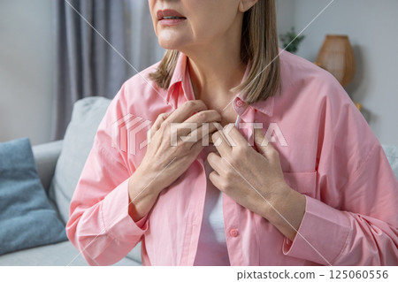 Woman suffering from heat and heartbeat and looking exhausted 125060556