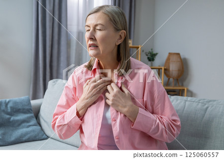 Woman suffering from heat and heartbeat and looking exhausted 125060557