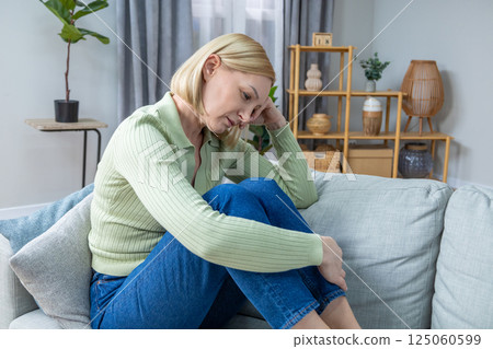 Blonde woman in her 50s feeling stressed and frustrated 125060599