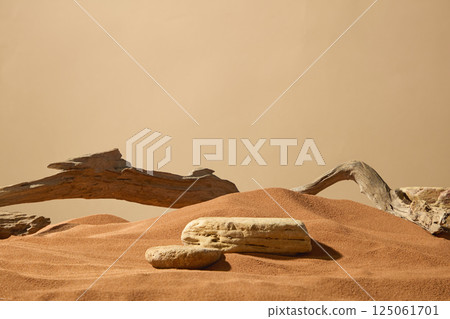Rough-surfaced boulders set in a sand field in the desert, with weather-worn edges. Dry brown sand forming undulating sand dunes, uneven surface. Wrinkled, rough and rugged dry tree branches. Rough-surfaced boulders set in a sand field in the desert, with weather-worn edges. Dry brown sand forming undulating sand dunes, uneven surface. Wrinkled, rough and rugged dry tree branches. 125061701