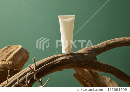Coarse branches with hollow lines running along the trunk, curving into a circle. Cosmetic tubes placed on a curved trunk, surrounded by arid woods. Brightly colored rocks forming a mountain. Coarse branches with hollow lines running along the trunk, curving into a circle. Cosmetic tubes placed on a curved trunk, surrounded by arid woods. Brightly colored rocks forming a mountain. 125061709