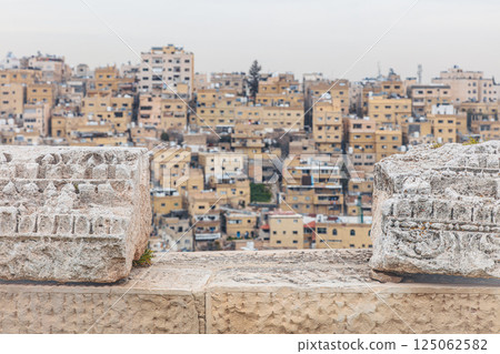 Amman city skyline rising above ancient roman ruins of the amman citadel, jordan Amman city skyline rising above ancient roman ruins of the amman citadel, jordan 125062582