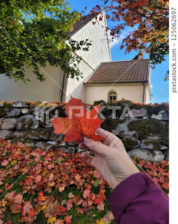 Fall Serenity, Young Woman with Maple Leaf Outside Swedish Church, Vertical 125062697