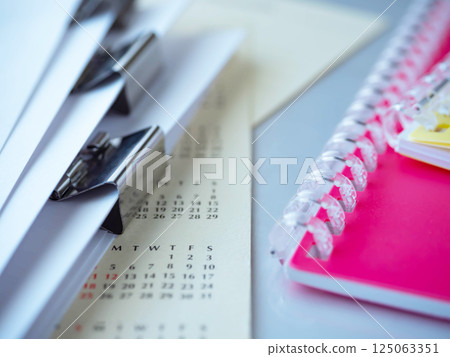 Calendar, documents and notebook on the table 125063351