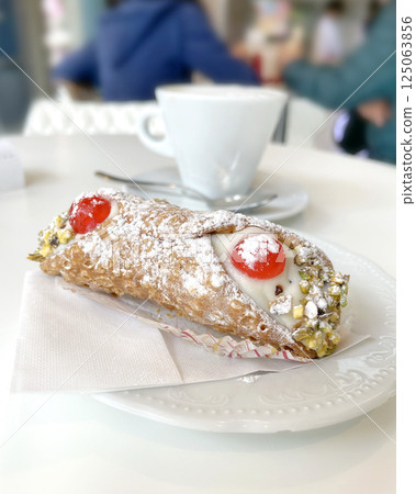 Cannoli on plate with cappuccino. Food and drink. Traditional Italian dessert. Cannoli on plate with cappuccino. Food and drink. Traditional Italian dessert. 125063856