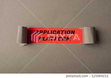 Torn piece of paper with the word Application written on it 125064212