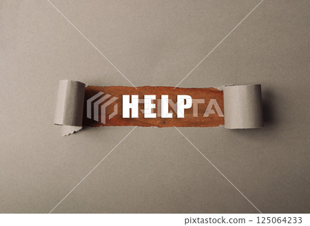 Torn piece of paper with the word HELP written on it Torn piece of paper with the word HELP written on it 125064233