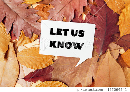 White sign with the words let us know written on it is placed on top of a pi 125064241