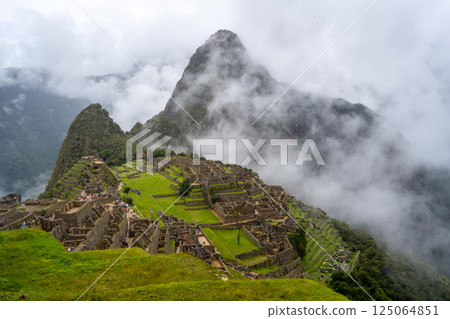 Panoramic view of Machu Picchu ruins surrounded by misty mountains, Peru Panoramic view of Machu Picchu ruins surrounded by misty mountains, Peru 125064851