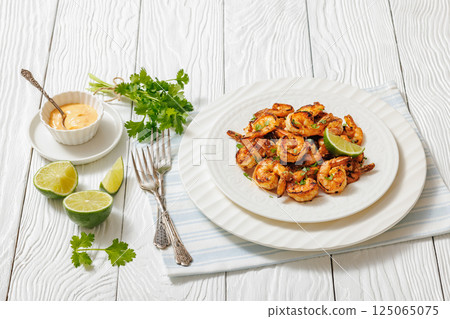 Grilled shrimp on a white plate with lime 125065075