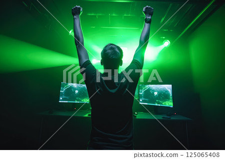 Man is standing in front of two computer monitors, one of which is green Man is standing in front of two computer monitors, one of which is green 125065408
