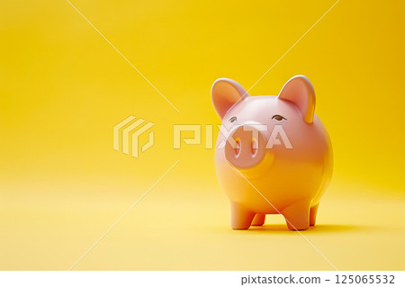 Piggy bank is sitting on a yellow background. 125065532