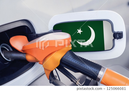 The flag of Pakistan on the lid of the gas tank of a car at a gas station in close-up. High or low gasoline prices at Pakistani gas stations. Gasoline prices are rising in Pakistan due to a shortage 125066081