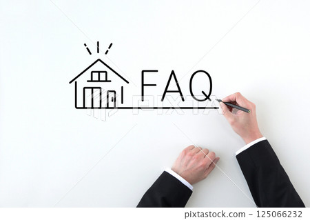Hands of a businessman drawing a banner with FAQs about home ownership 125066232